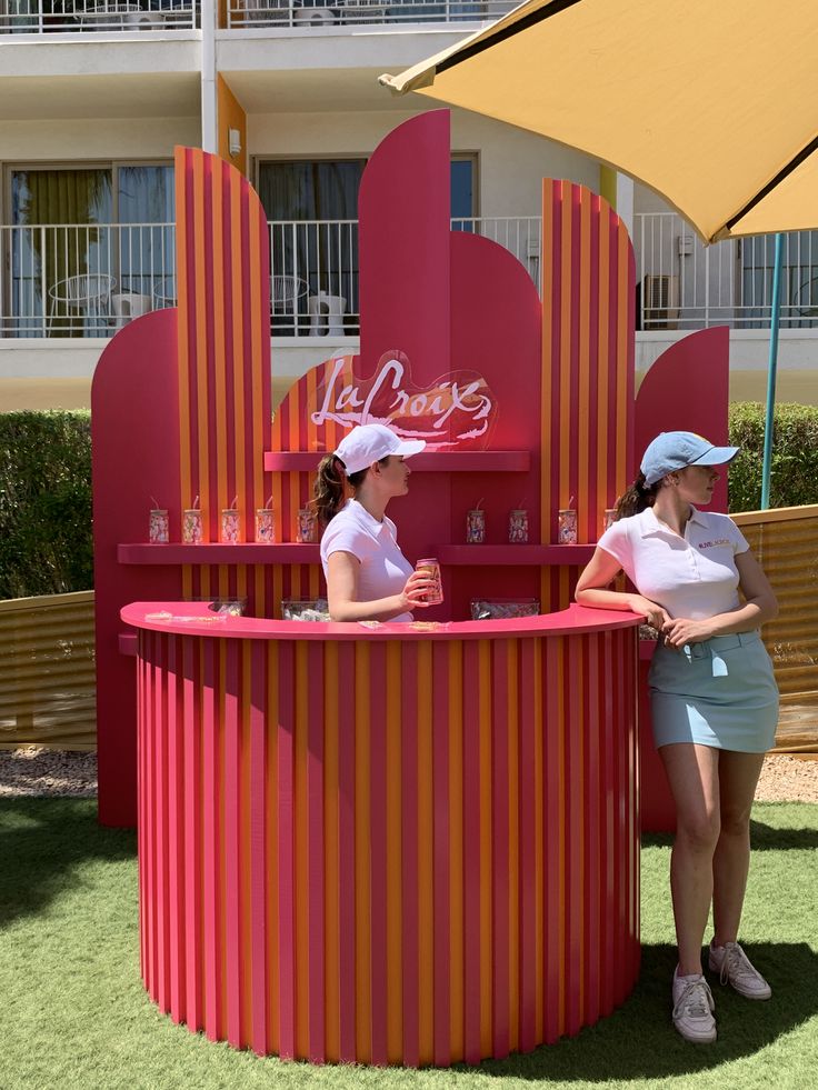 Bright pink bar setup for events with two women at the counter
