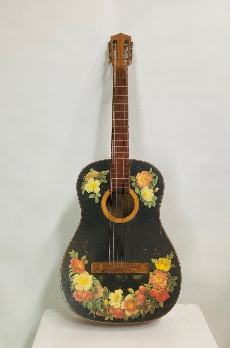 Floral design vintage guitar on a white background