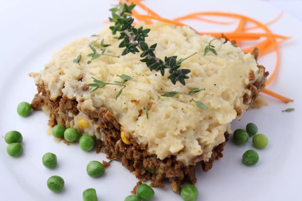 Vegan Shepherd's Pie served with peas and carrots