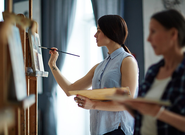 Two women painting in a studio setting