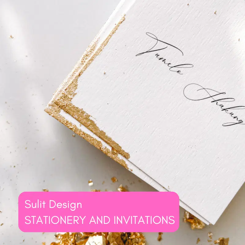 Wedding invitation with gold leaf edge and cursive text