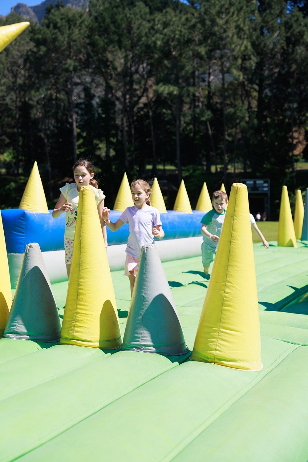 Children running through an inflatable obstacle course
