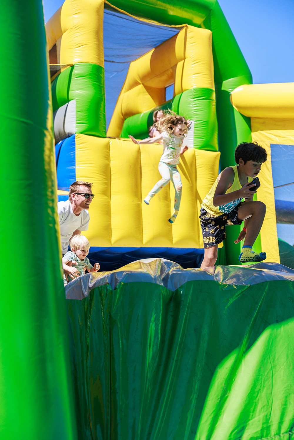 Children playing on an inflatable obstacle course