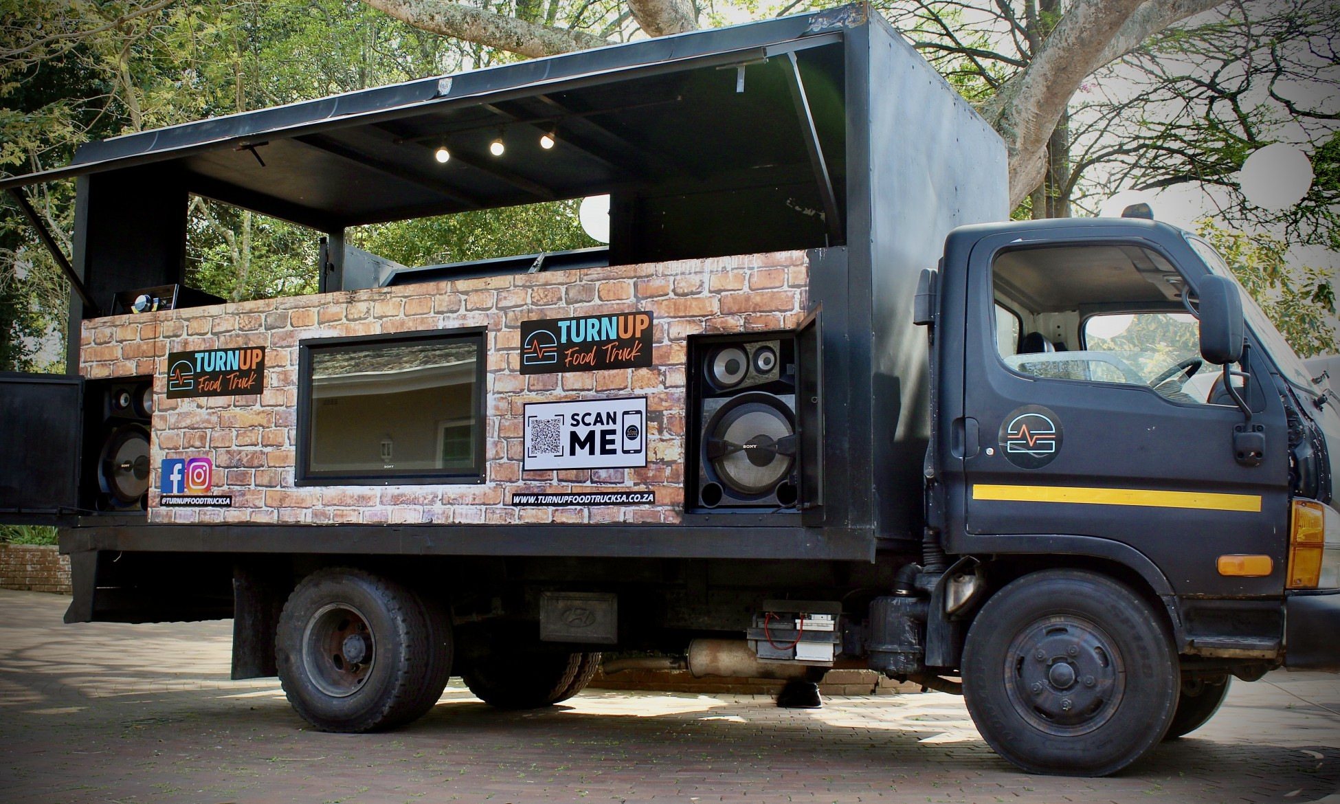TurnUp Food Truck parked, showing service area and sound equipment.
