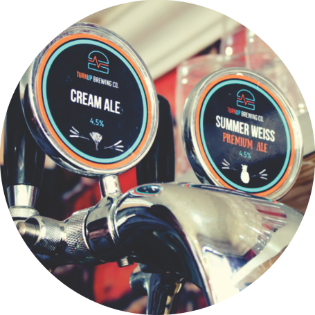 Two beer taps labeled Cream Ale and Summer Weiss Premium Ale