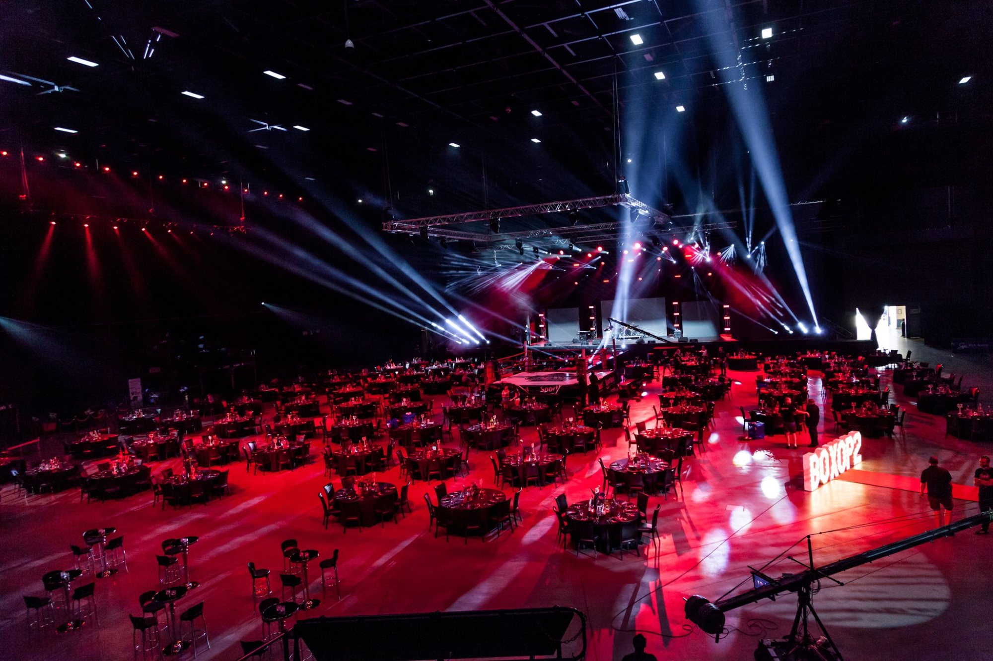 A large event space with tables and dramatic lighting