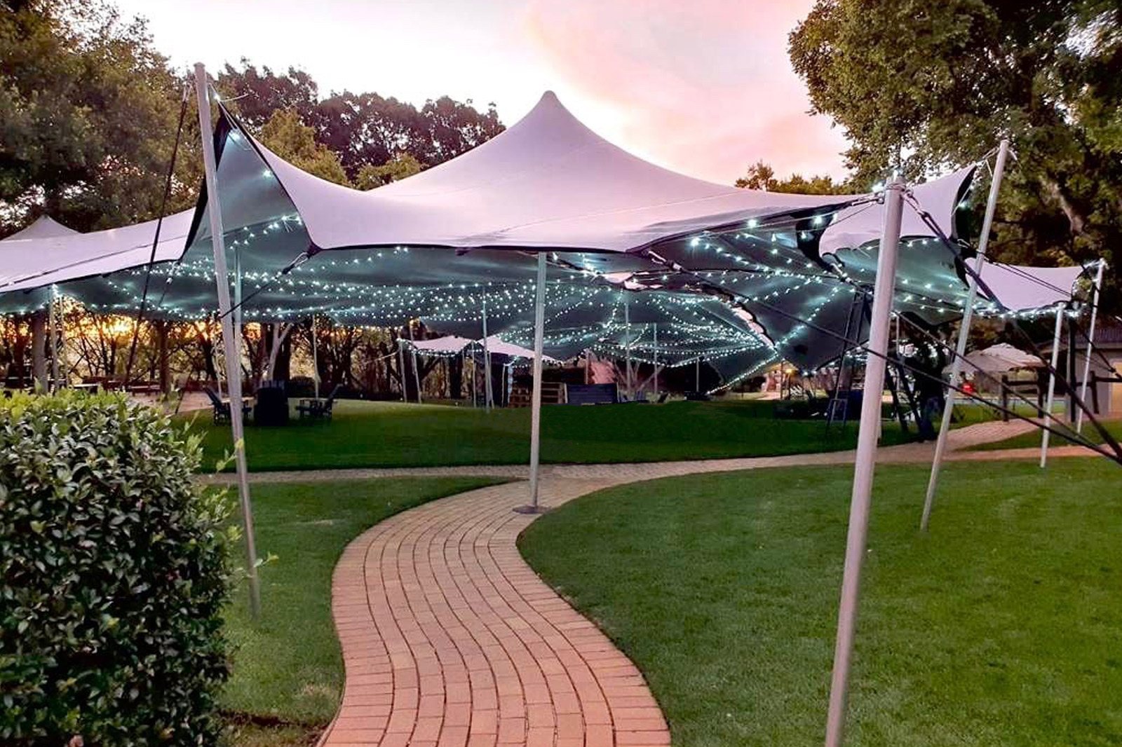 Stretch tent with lights set up in a garden