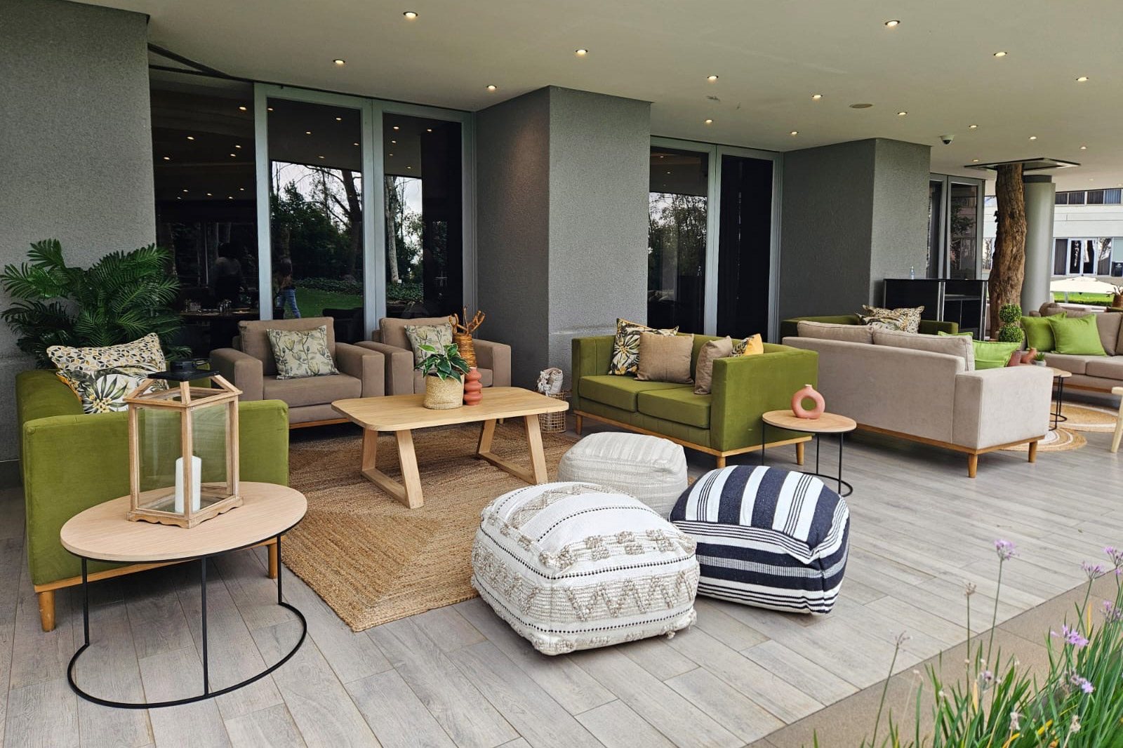 Stylish lounge setup with sofas, poufs, and decor