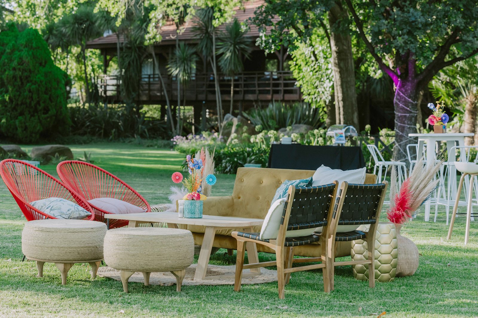 Outdoor lounge setup with various seating options and decor.