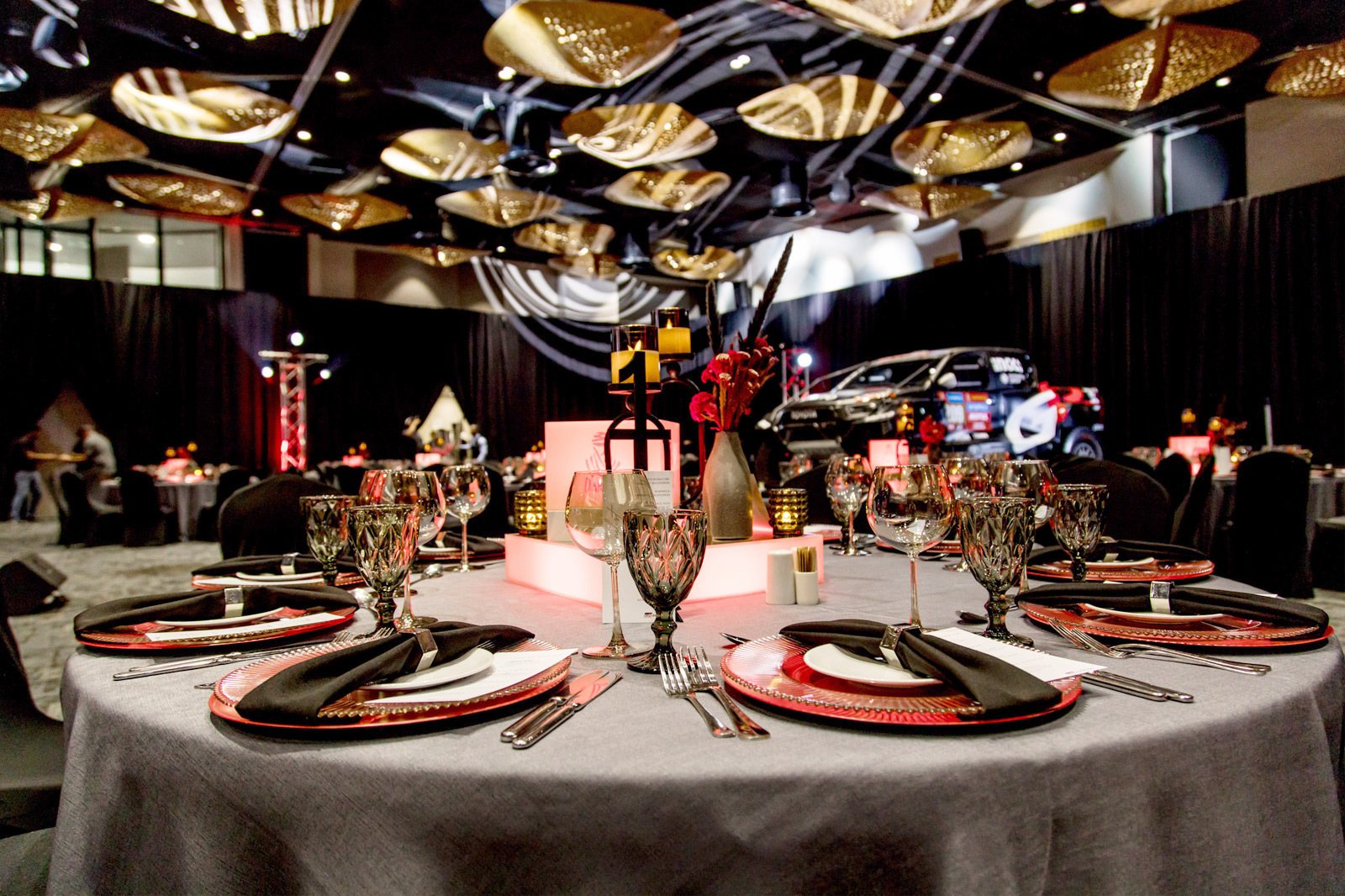 Table set with elegant glassware, cutlery, and decor.