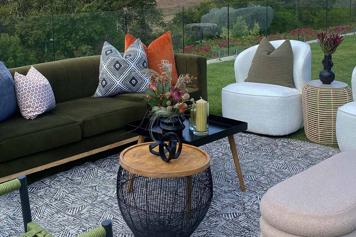 Lounge area with sofa, cushions, and decorative tables