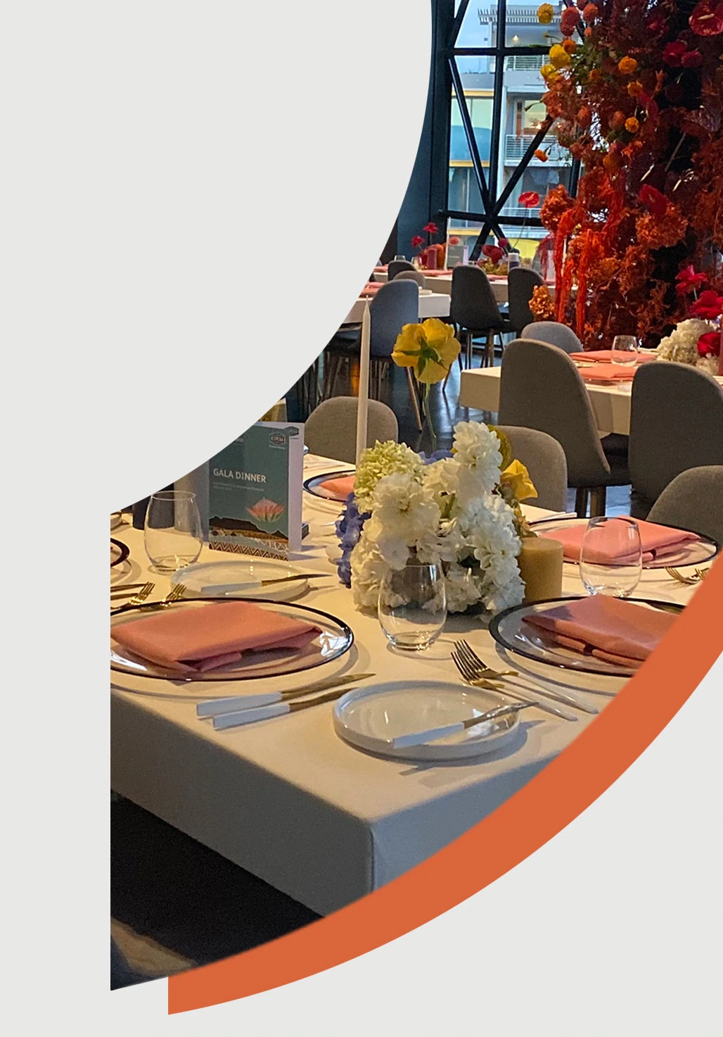 Table setup for a gala dinner with floral centerpieces.