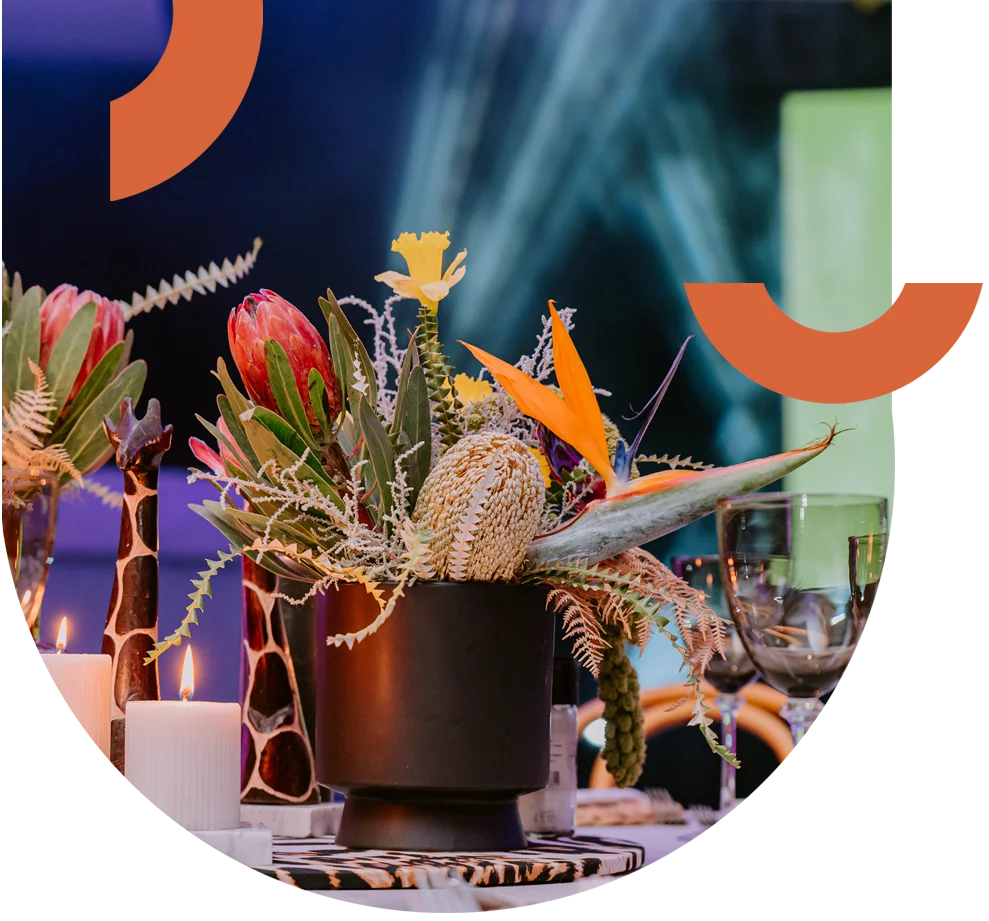 Colorful floral centerpiece with candles and tableware
