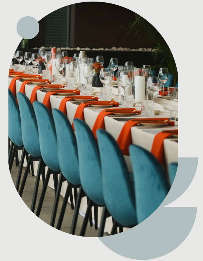 Row of blue chairs with orange accents at a dining table
