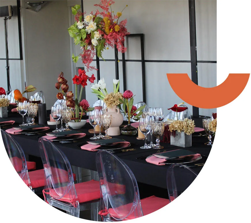 Decorated dining table with floral arrangements and glassware