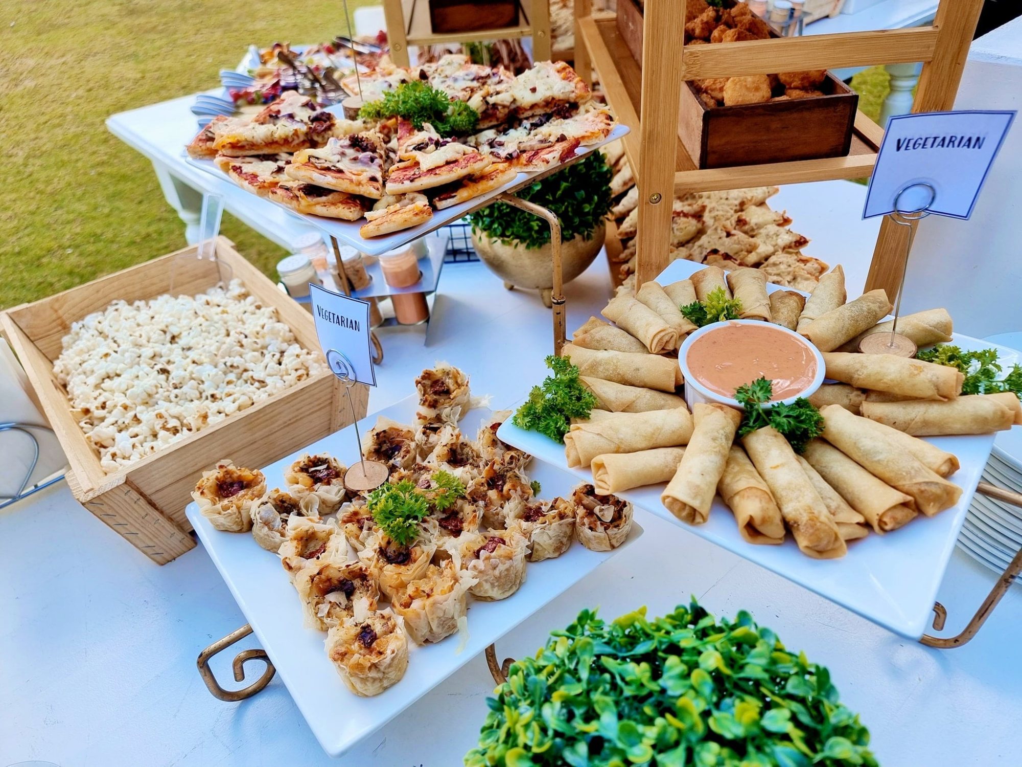 A display of assorted gourmet snacks, including spring rolls and pastries.