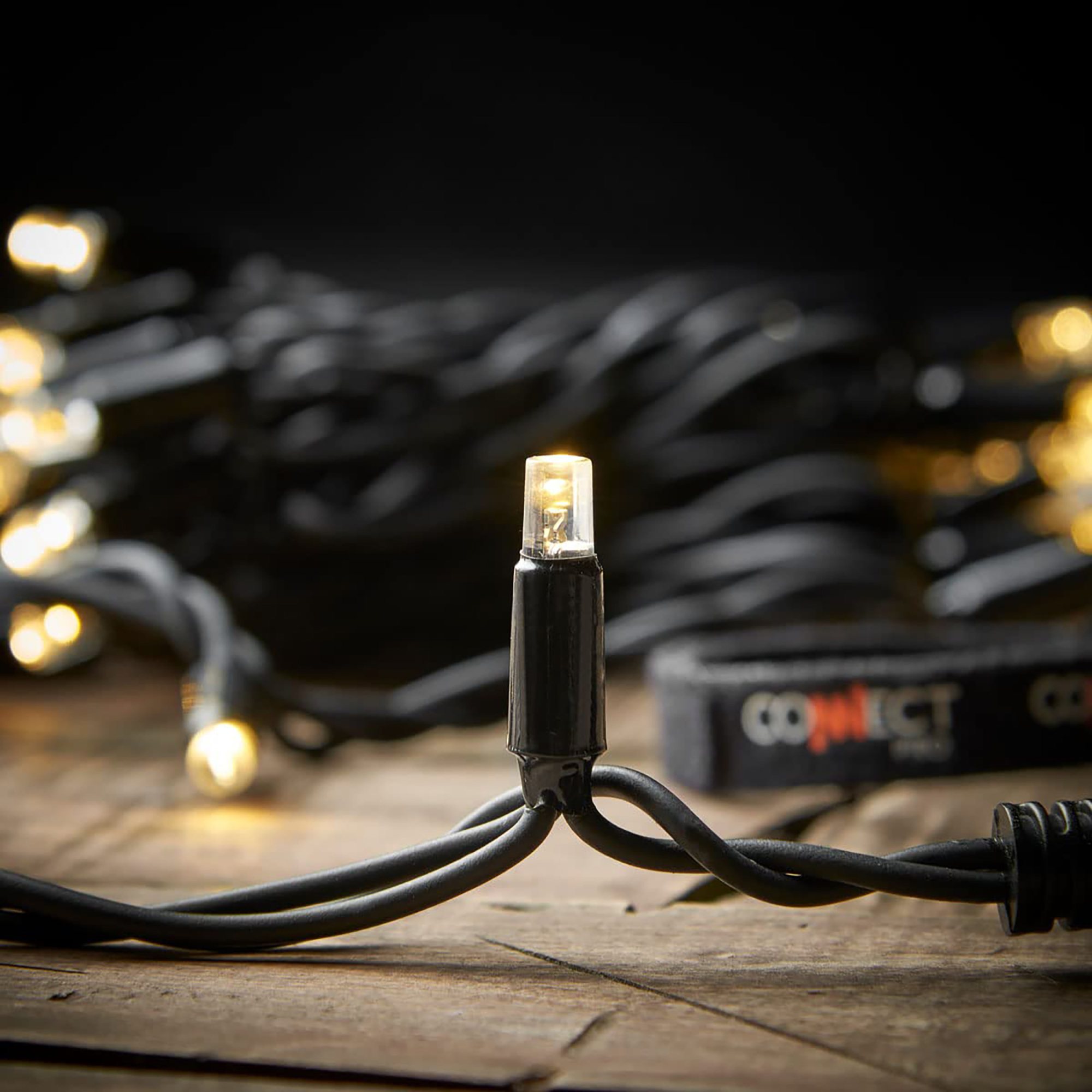 Close-up of festoon string lights with a black cord