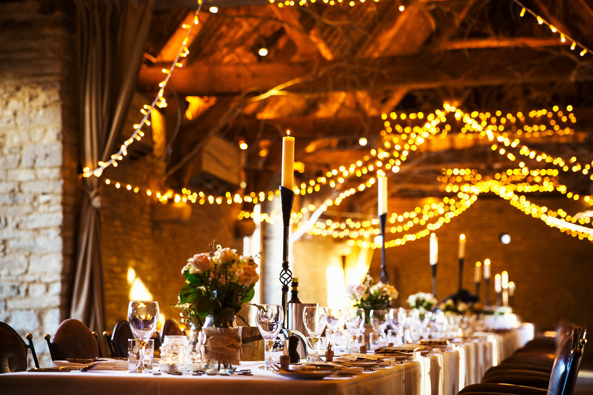 Dining area with fairy lights and elegant table settings