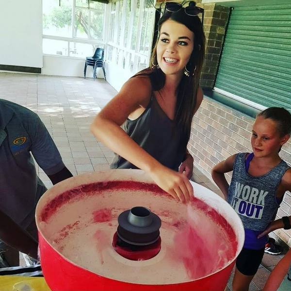A person making cotton candy at an event