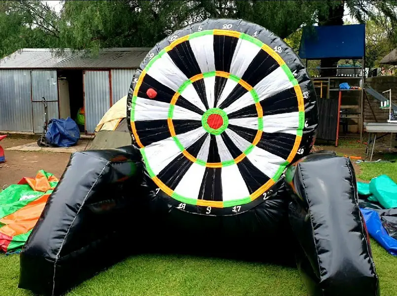Large inflatable dartboard set up on grass