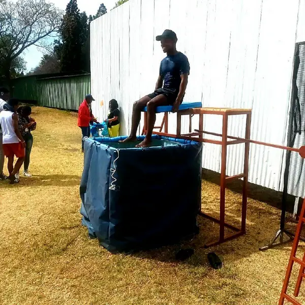 Dunk tank setup with a participant ready to be dunked.