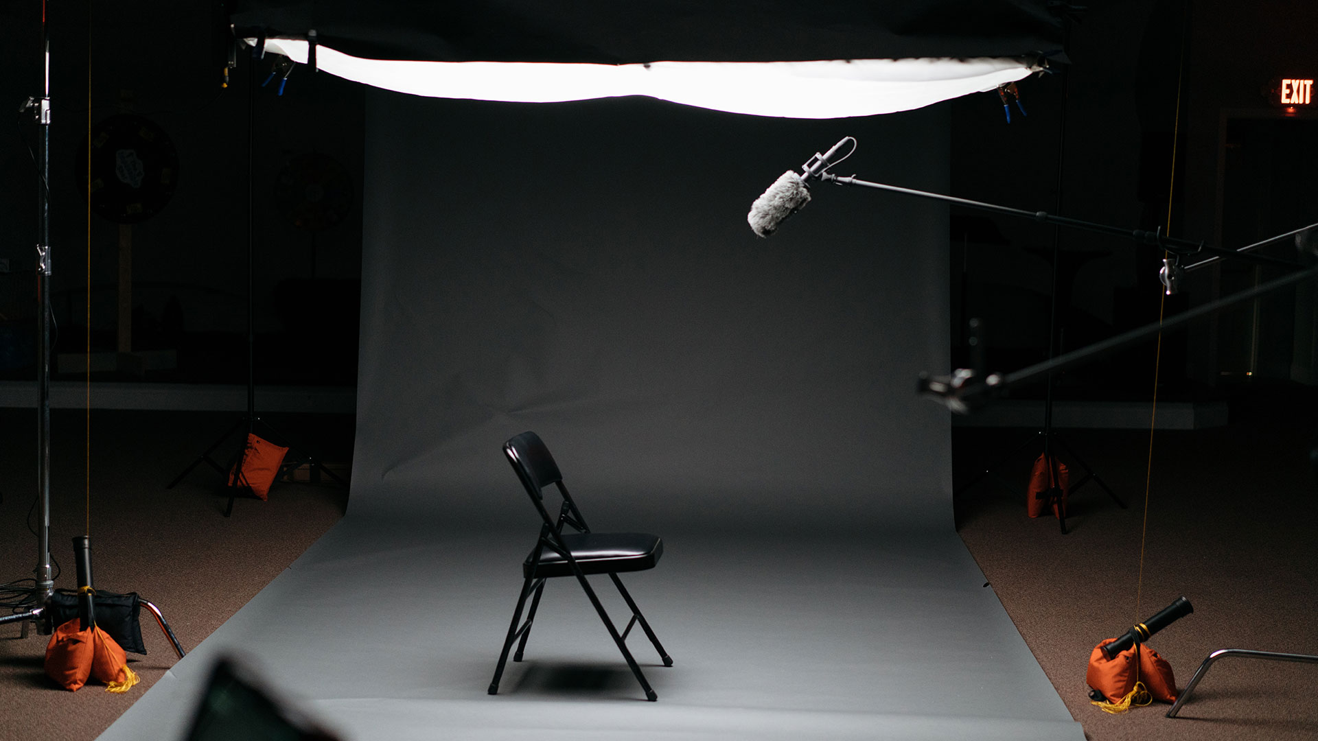 Empty chair under studio lighting for video production setup