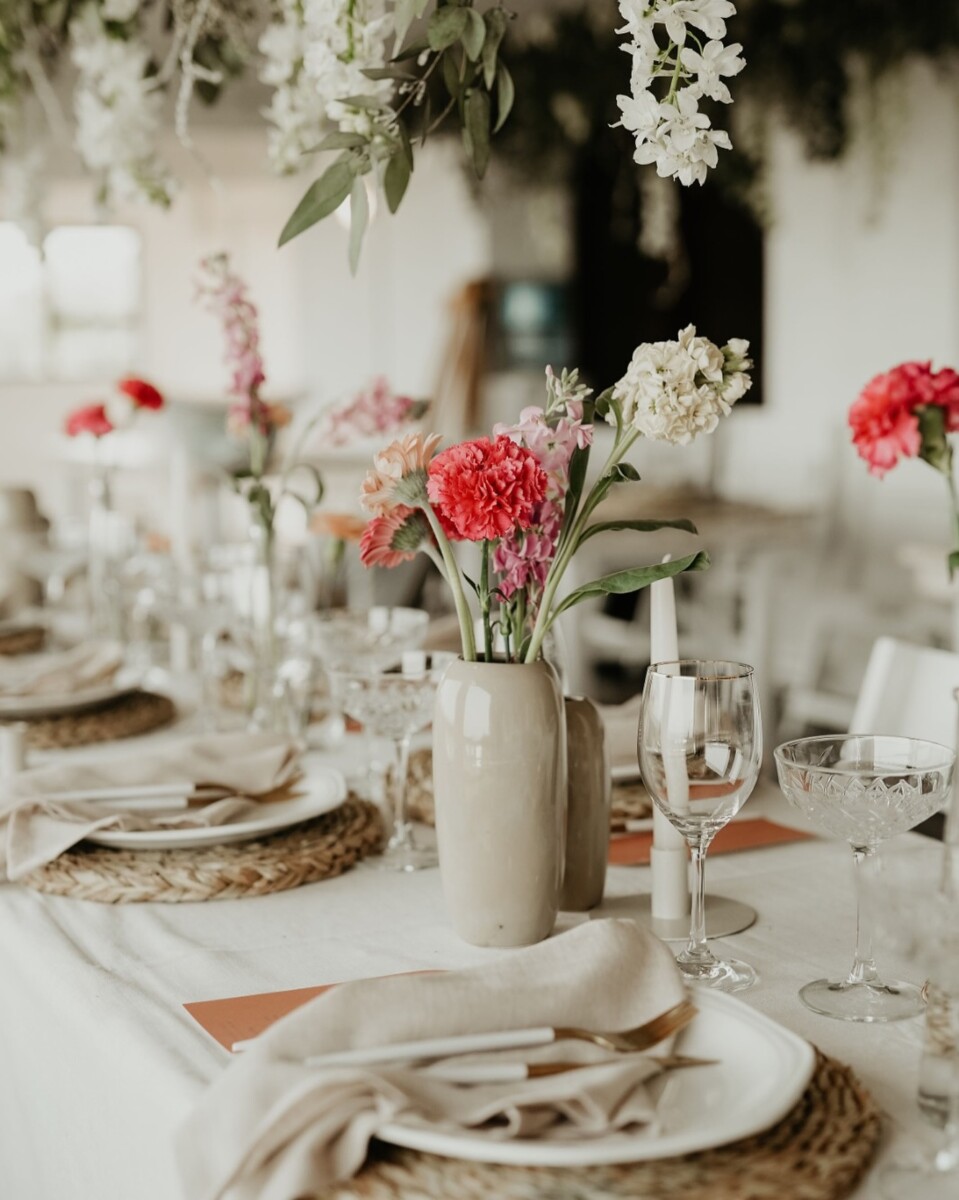 Wedding table arrangement with flowers and glassware