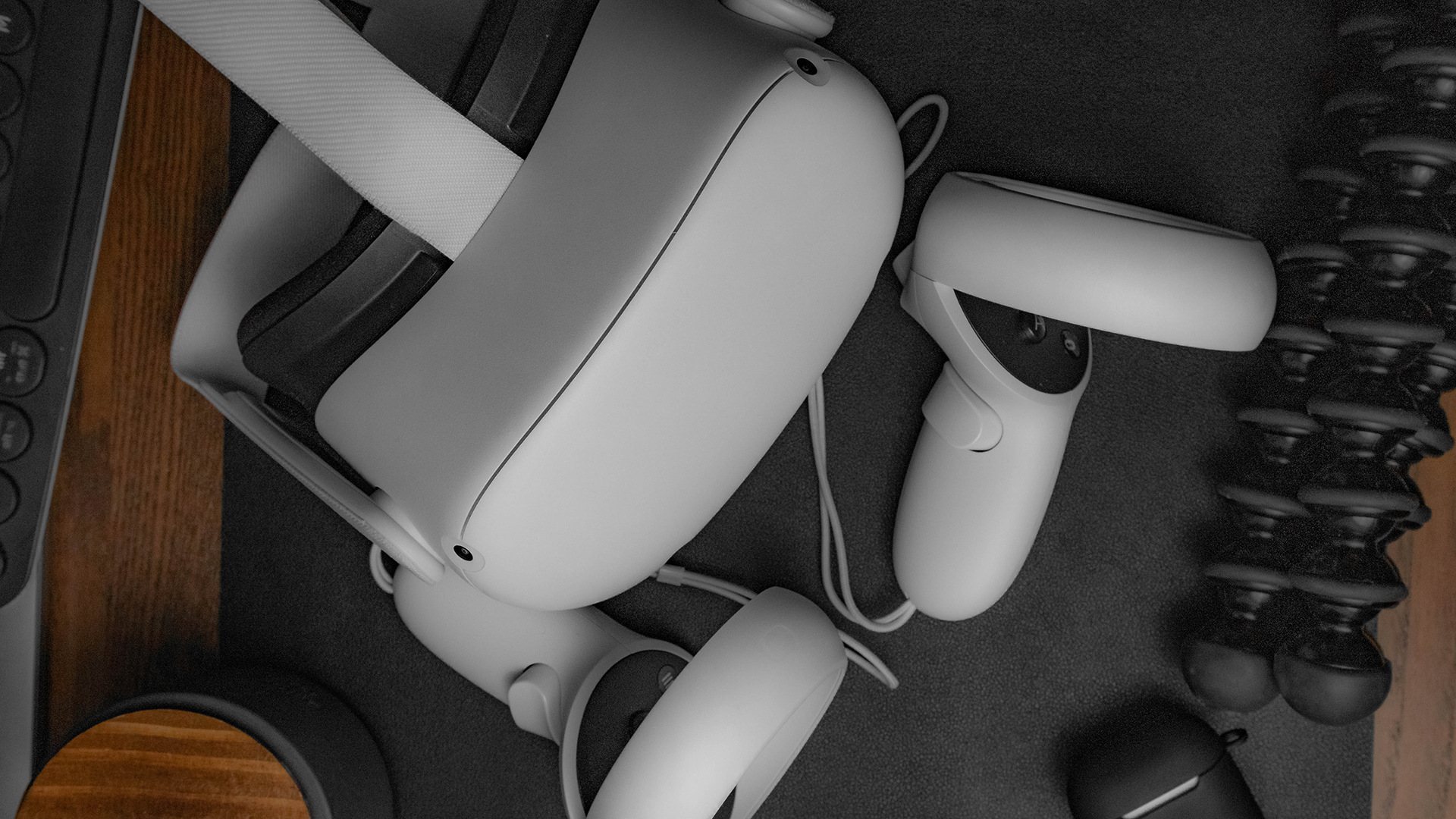 Close-up of Meta Quest VR headset and controllers on a desk.
