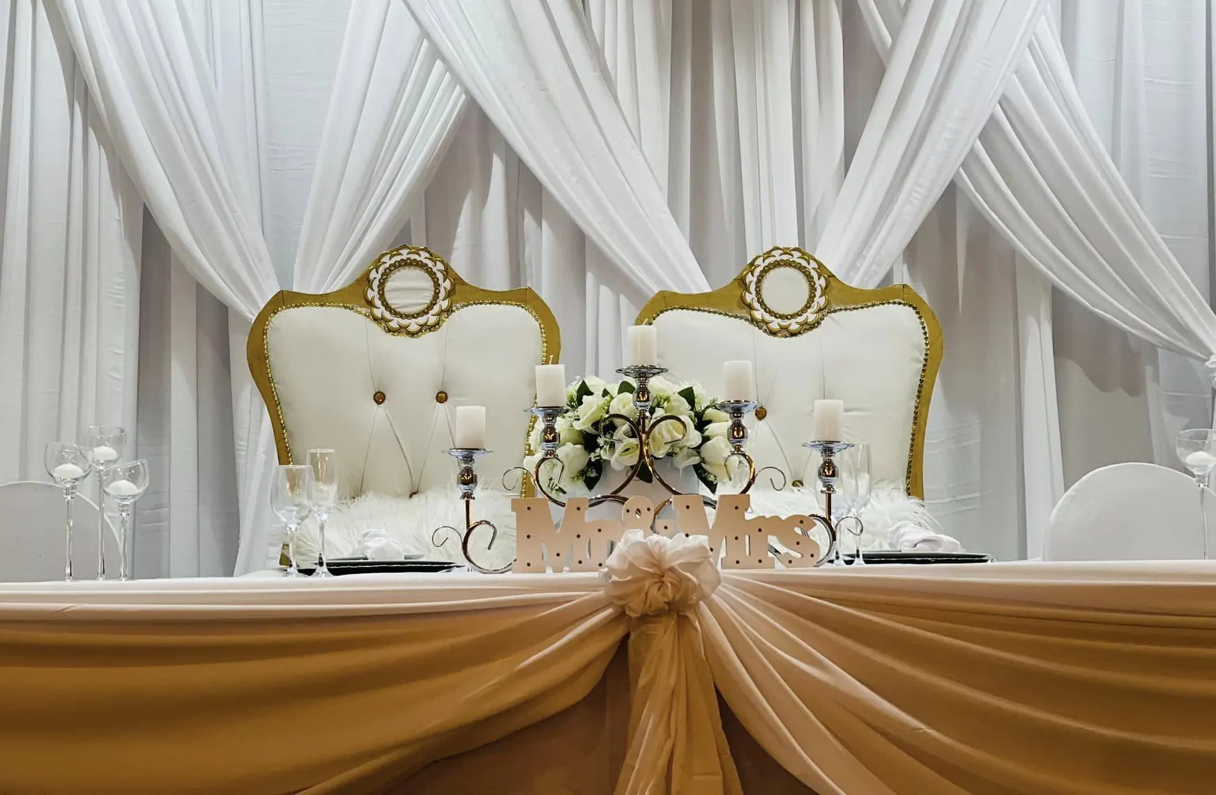 Stylish bridal table with decorative elements and floral arrangements.