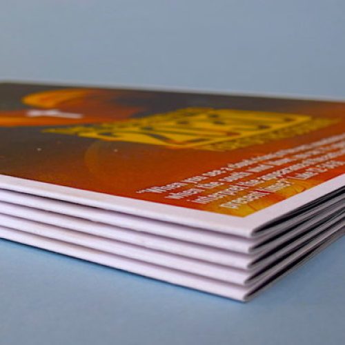 Stack of colorful digital invitations on a blue surface