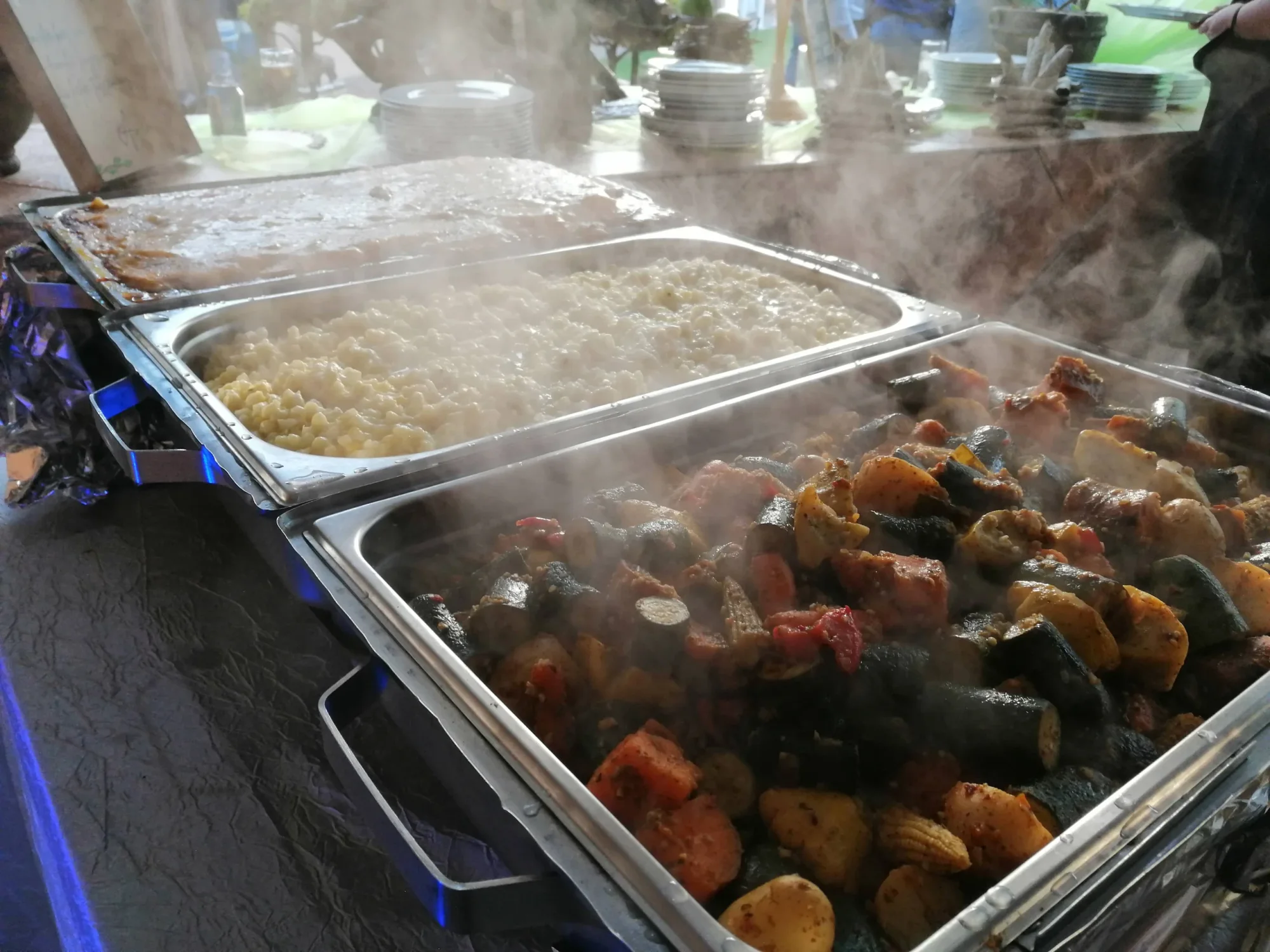 Buffet trays with macaroni, vegetables, and sides