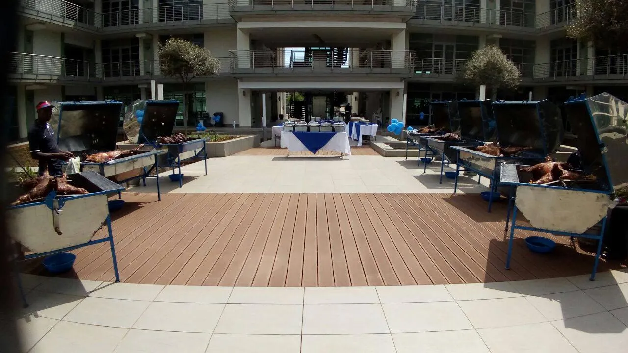 Spit braai setup with multiple cooking stations on a patio