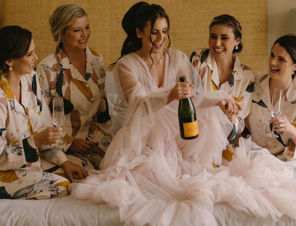 Bridal party celebrating with champagne before the wedding