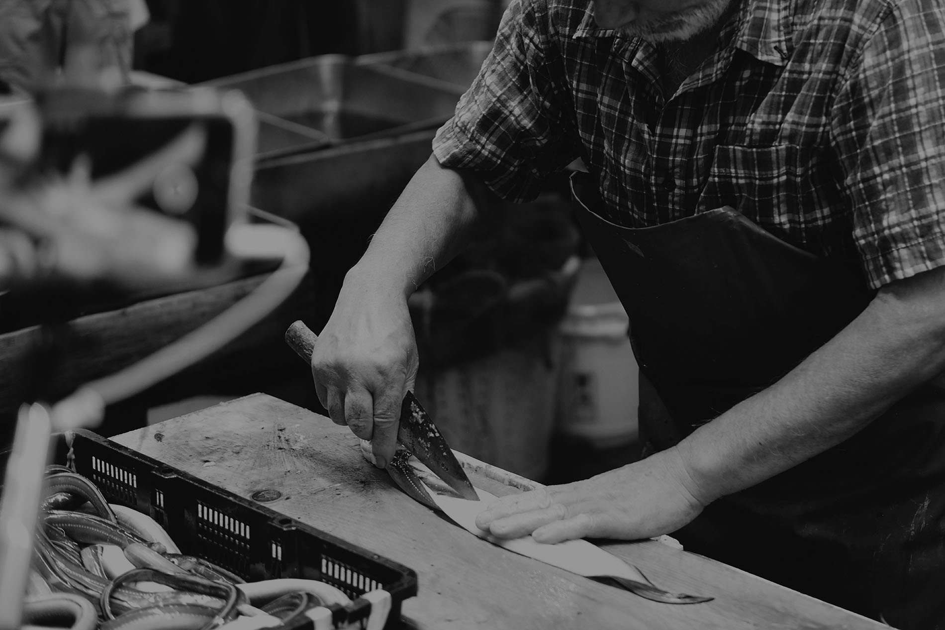 Chef filleting fresh fish on a cutting board