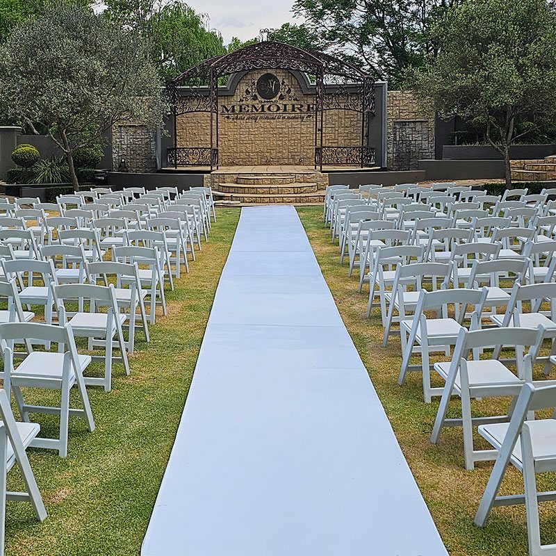 Light blue chapel aisle leading to a decorated stage area