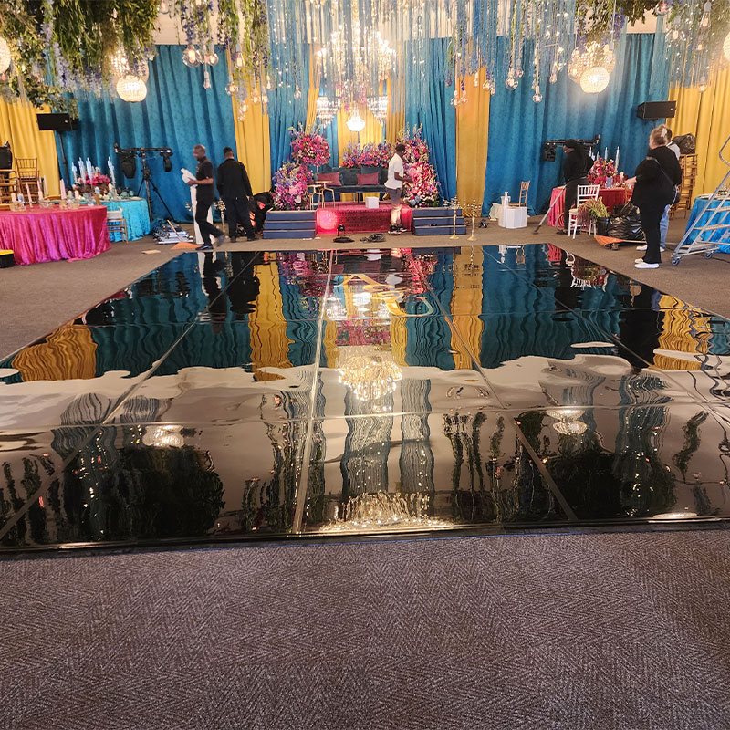 Black high gloss dance floor setup at an event
