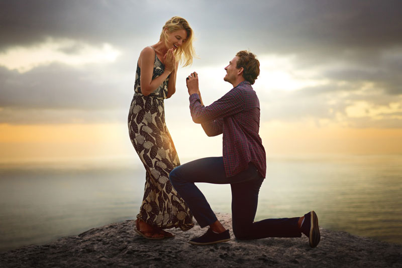 Couple celebrating an engagement on a scenic beach