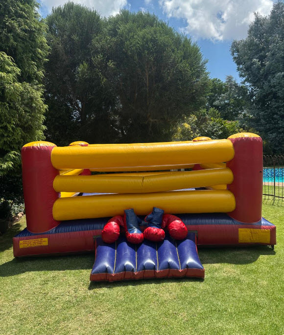 Brightly colored toddler jumping castle in a garden setting