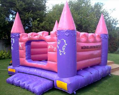 Pink and purple themed jumping castle with pointed towers