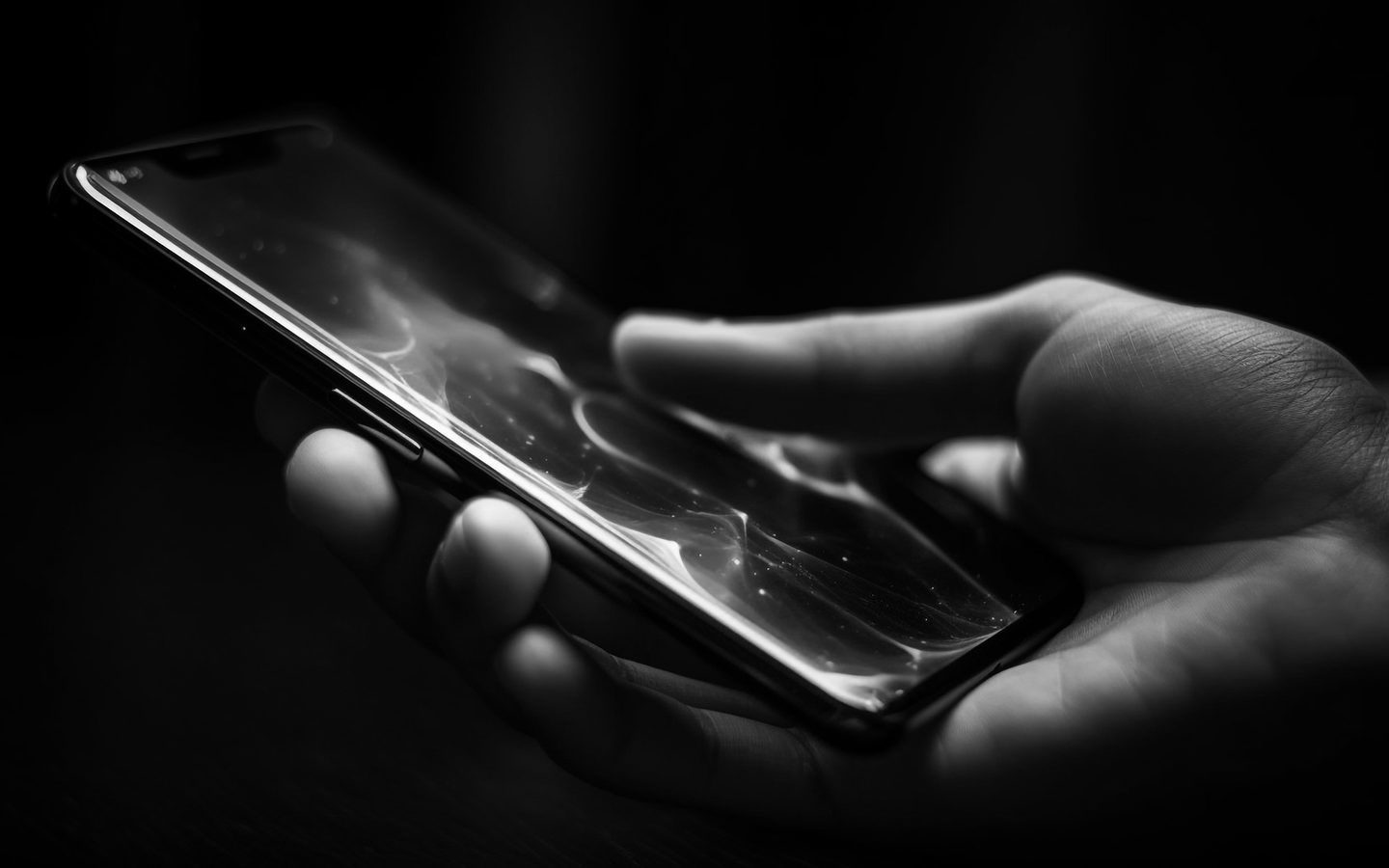 Hand holding a smartphone with a touchscreen display.
