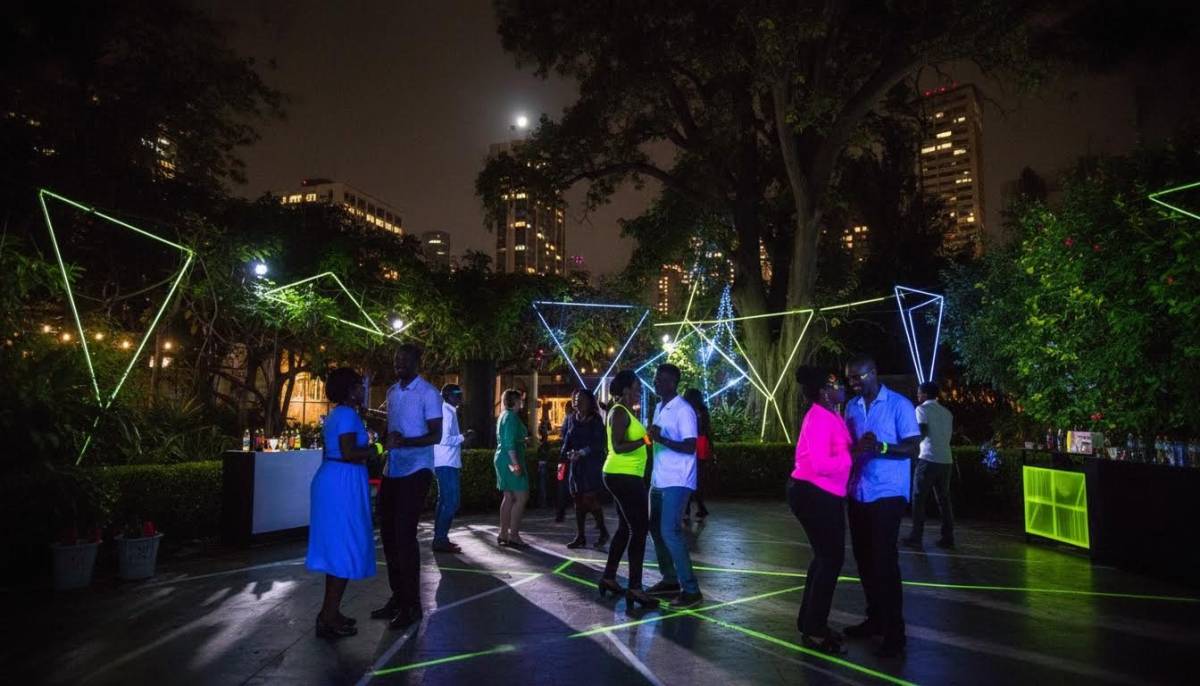 Guests dancing at a neon garden bachelorette