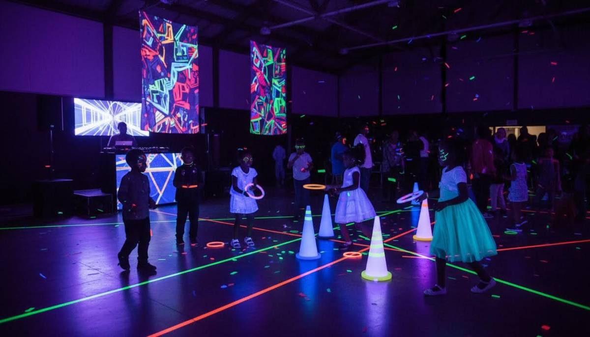 Children playing a glowing ring toss game