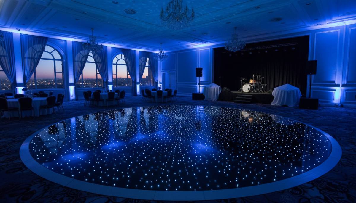Starlight dance floor in a Pretoria hall with blue evening uplighting.