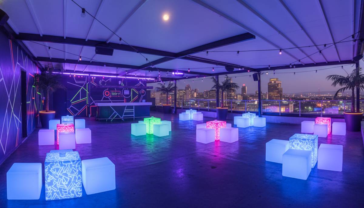 UV blacklight lounge with LED cubes in a Sandton rooftop venue.